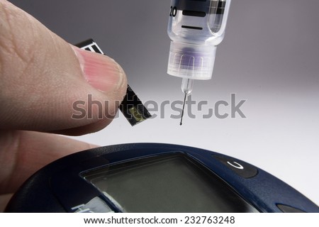 insulin syringe with strip measuring blood glucose