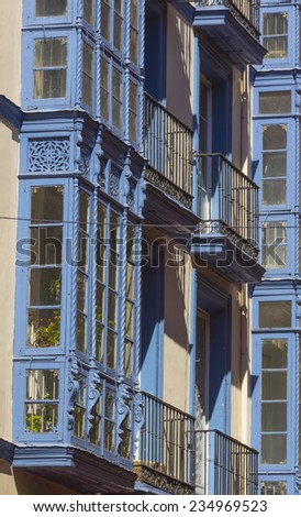 Typical old balconies enclosed with wood and glass