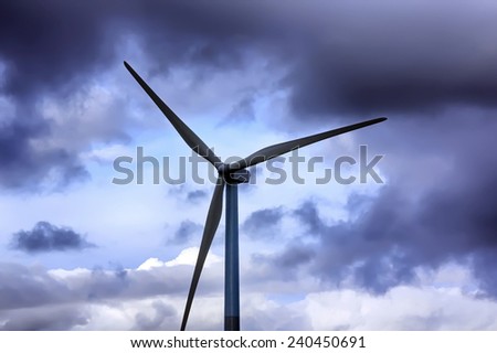 wind energy windmills in a dark storm, electric generators