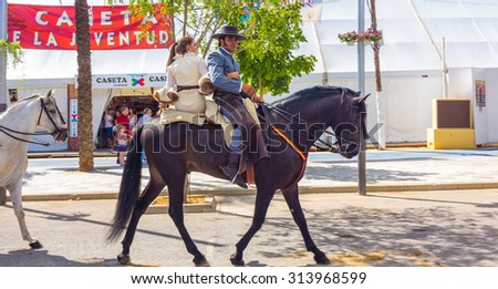 ANDUJAR,SPAIN - September, 6: \
men women and children involved walking on their mounts during the famous fair of the Andalusian horse on September, 6, 2014 in Andujar, Spain