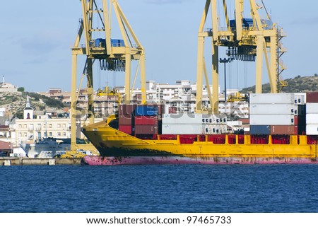 huge freighter ship yellow downloading containers