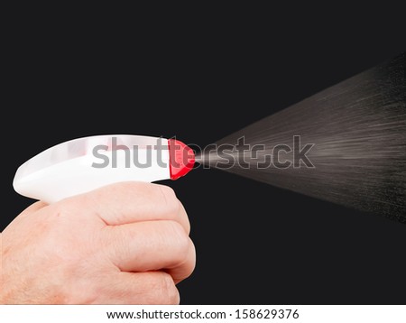 human hand spraying cleaning agent - studio shot