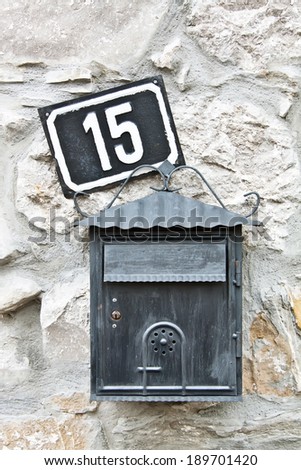 mail box and house number on the wall