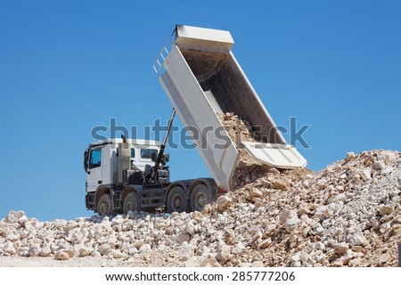 tipper truck unload crushed rocks