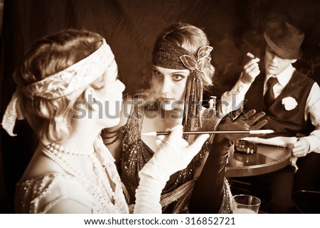 flapper girls and young gangster smoking in the bar