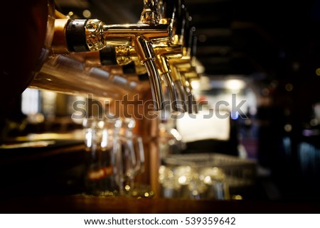 golden shiny beer taps in beer bar