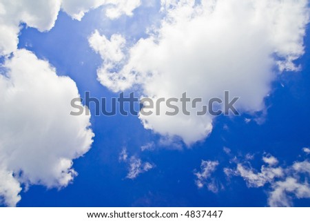 brightly lit white clouds on a deep blue sky
