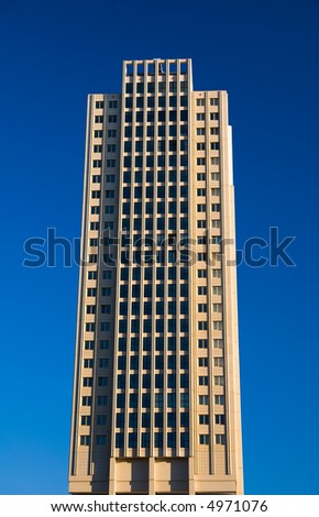 isolated office building tower in blue sky