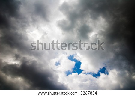 dark clouded sky with bright blue spot