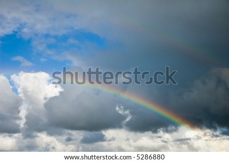 real rainbow between dark stormclouds