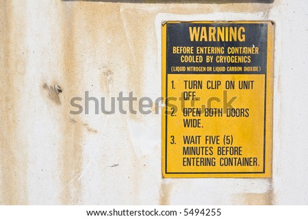 warning label on white rusty freight container