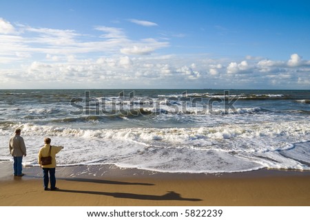 Two elder people watching over the sea