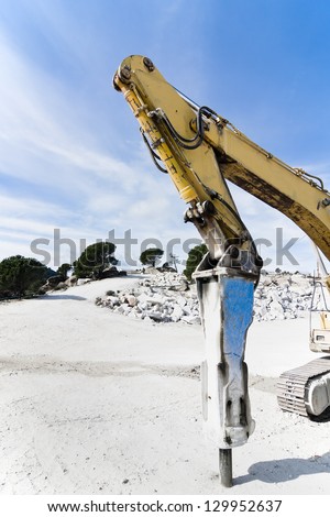 rotary hammer placed on an excavator in a granite quarry