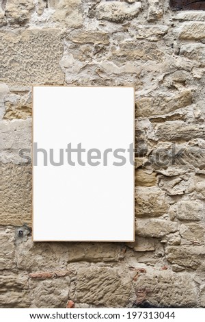 white sign hanging on a rustic stone wall