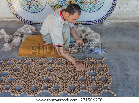 Fes, Morocco - May 11, 2013: Moroccan mozaic artist at work in a pottery shop