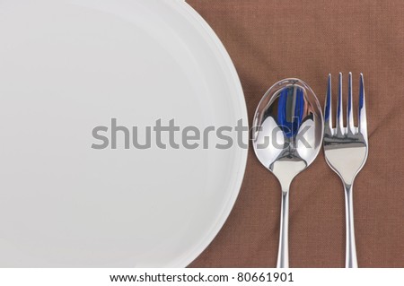 Spoon and fork on a napkin as a dining room serving.