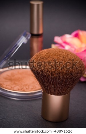 make up brush and powder box  still life in vertical composition