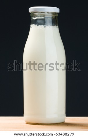 glass milk bottle in vertical composition