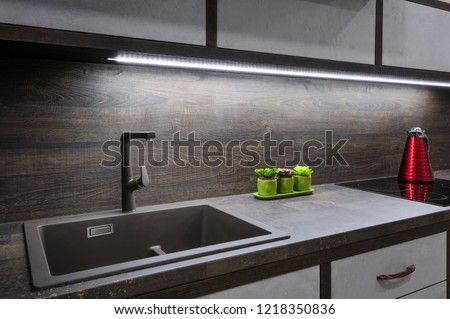 Luxury cozy modern dark brown kitchen interior, induction stove, minimalistic clean design
