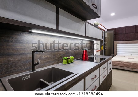 Luxury cozy modern dark brown kitchen interior, induction stove, minimalistic clean design