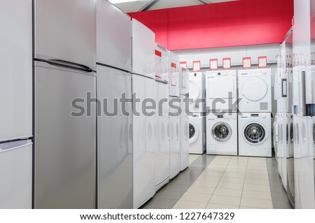Rows of fridges and washing mashines in appliance store
