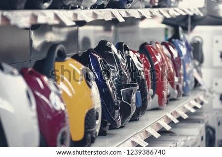 Row of variety vacuum cleaners in appliance store. Selective focus, toned image