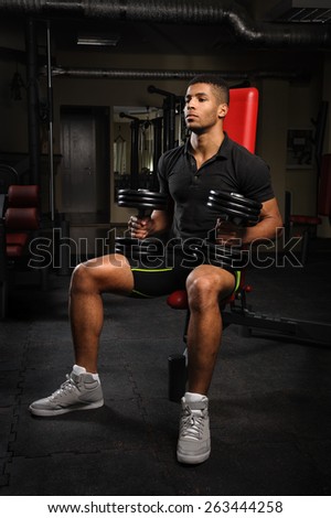 young man sitting on bench at gym