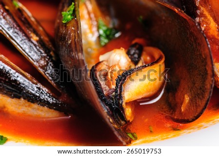 Macro shot of mussels prepared in italian rustic style with wine and parsley