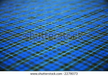 checkered blue celtic style fabric textured background. shallow DOF.