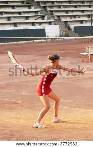 blond girl playing tennis at open court