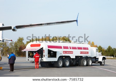airplane is being refueled in the airport
