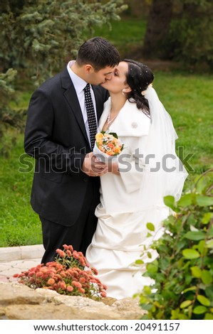 just married couple kissing in the park