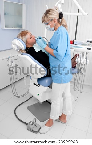 dentist at work, tooth drilling