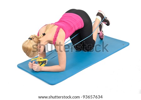 Young blond girl doing kneeling butt blaster exercise using rubber resistance band. position 1 of 2.