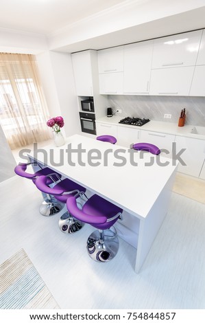 Modern white kitchen interior with purple bar chairs, minimalistic clean design