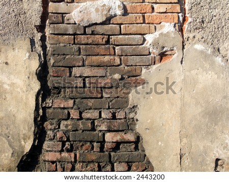 Old wall with red bricks on strong sunlight
