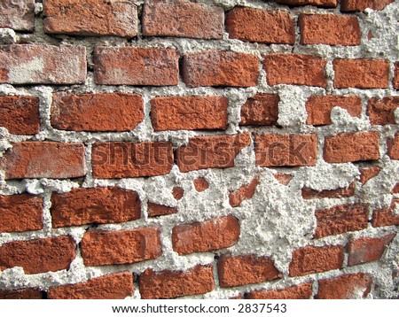 Part of concrete and brick street wall