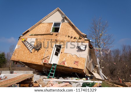 A home heavily damaged by an F2 tornado that swept through Oregon Twp in Lapeer County, MI on March 15, 2012. The house was lifted from its foundation. This photo was taken the next day.