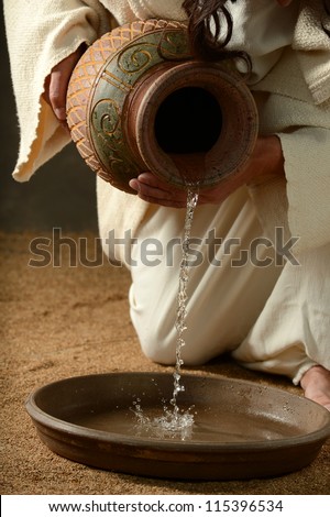 Detail of Jesus pouring water on a neutral background