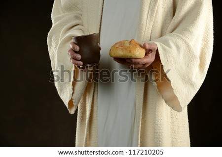 Jesus holding bread and a cup of wine as a metaphor