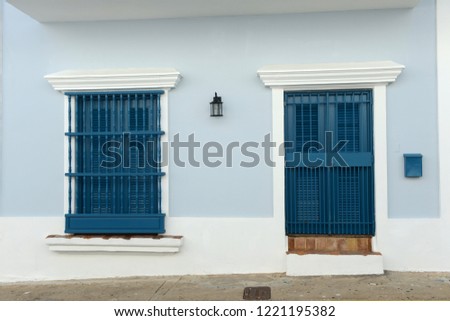 Detail of an old San Juan house in Puerto Rico with door and window in blue tones