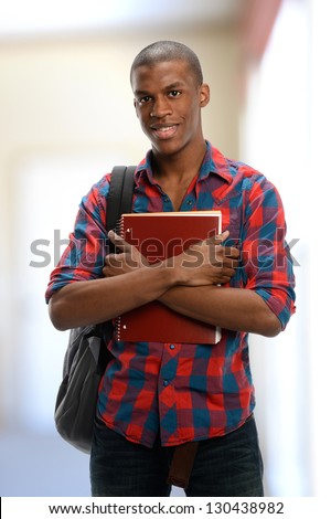Young Black Student holding a copybook isolated on a white background