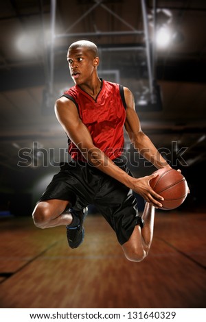 Young Basketball player jumping inside a court