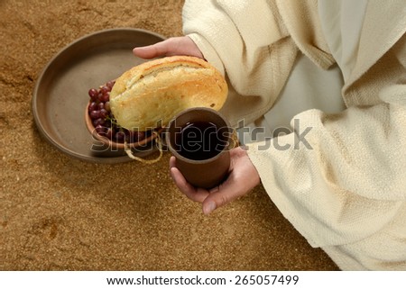 Jesus during communion holding bread and wine