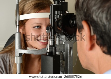 Eye Doctor druring a test with young patient in his office