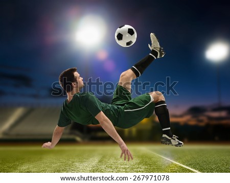 Soccer Player Kicking the ball inside a stadium at night