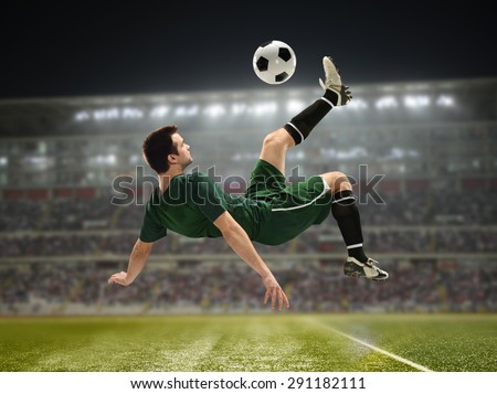 Soccer Player Kicking the ball inside a stadium at night