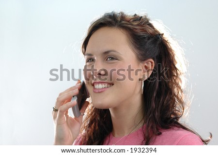 Young woman on the cell phone with white background