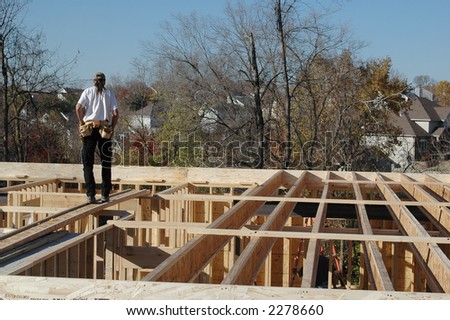 Construction builder on site with houses on the background