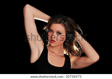 Young beautiful fashion woman with headphones isolated on a black background